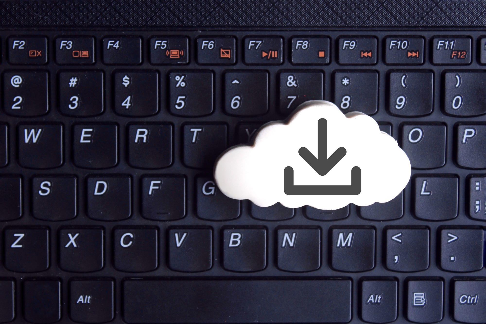 White cloud with download icon on keyboard
